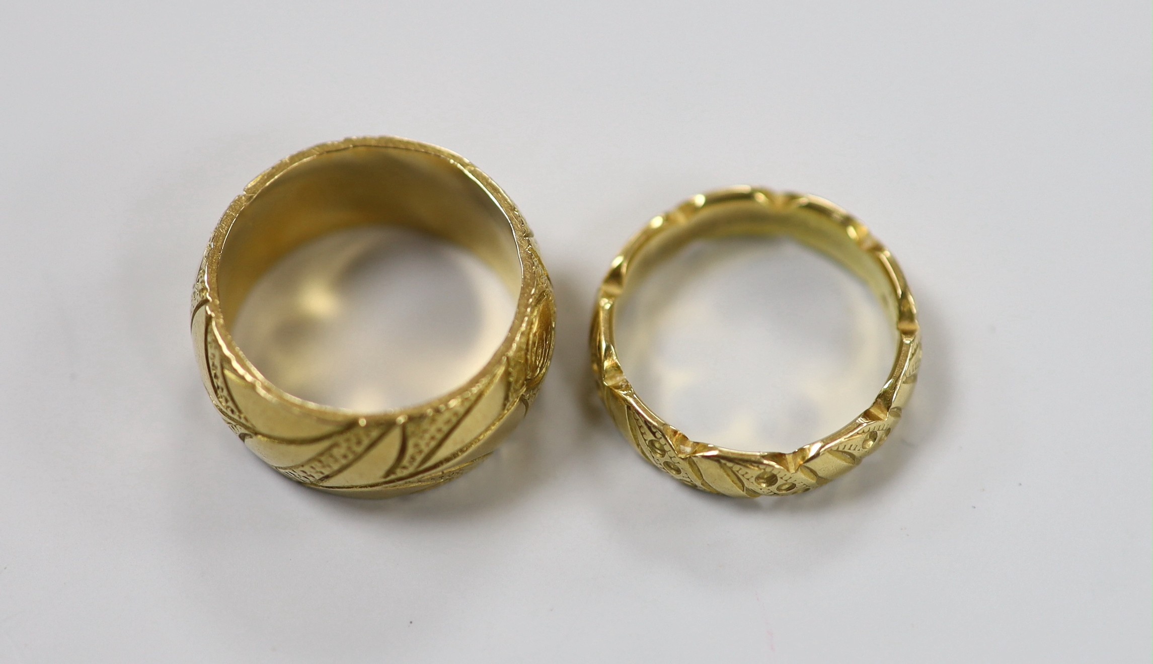 Two engraved 18ct gold wedding bands, sizes K and L/M, 15.7 grams.